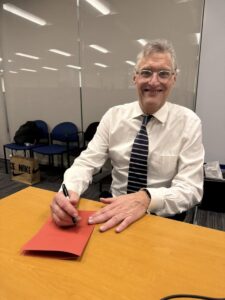 Man at table with card