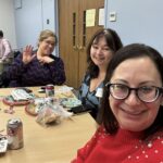 three people at a table smiling