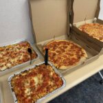 boxes of pizza and various food